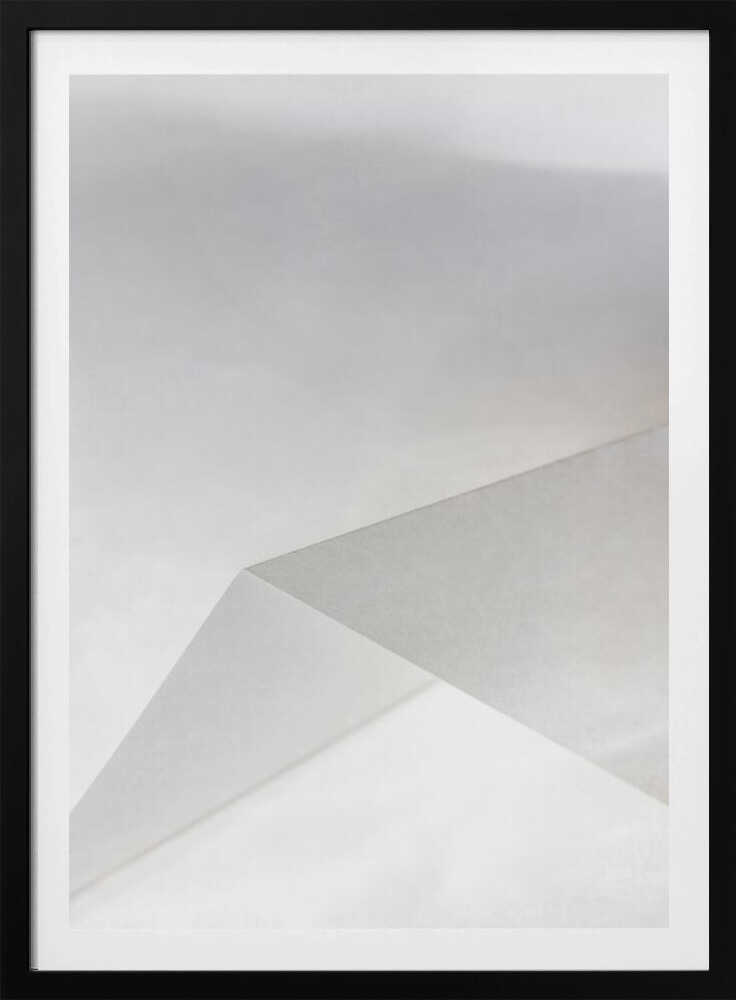 Minimalist abstract art of folded paper creating clean lines and geometric shapes in shades of grey and white.