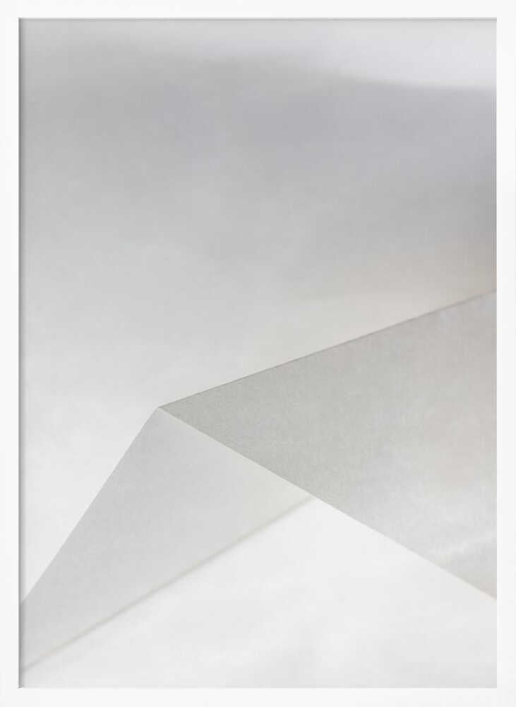 Minimalist abstract art of folded paper creating clean lines and geometric shapes in shades of grey and white.