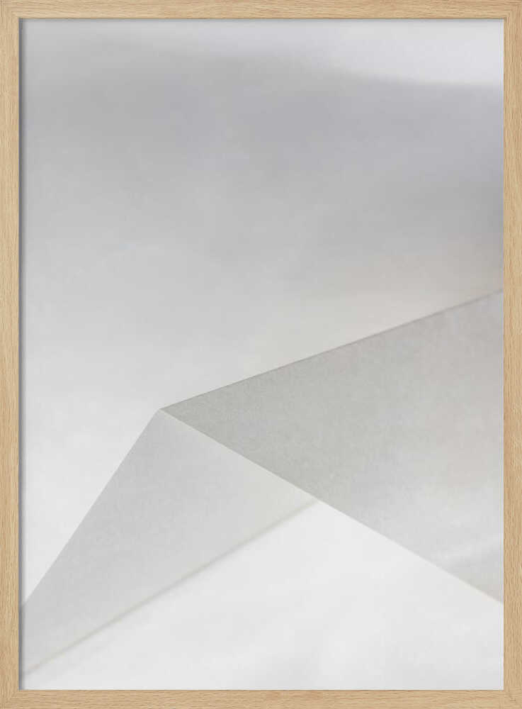 Minimalist abstract art of folded paper creating clean lines and geometric shapes in shades of grey and white.