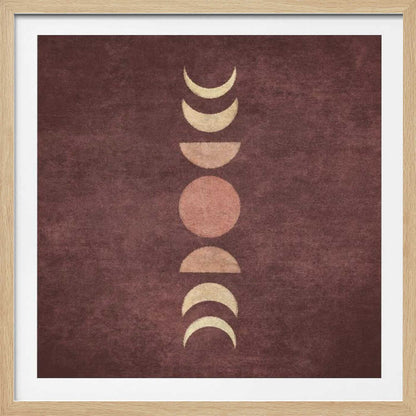 A minimalist piece of framed art showing the phases of the moon arranged vertically against a textured, deep maroon background. The moon shapes are colored in shades of cream and dusty rose, with the full moon in the center. Print
