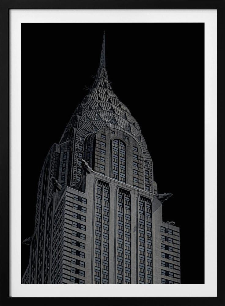 A dramatic, low-angle, black and white photograph of the top of the Chrysler Building, showcasing its iconic Art Deco spire and architectural details against a solid black background. Decor