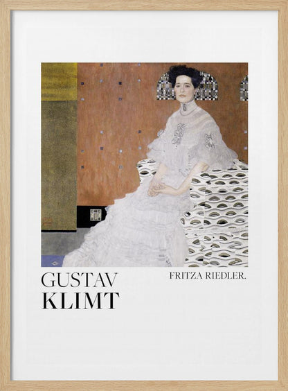 A framed art print of Gustav Klimt's 1906 painting, 'Portrait of Fritza Riedler'. A woman with dark, upswept hair wearing a detailed, high-necked white gown sits in a patterned chair against a warm, textured brown and gold background. Below the artwork, on a white border, the text 'GUSTAV KLIMT' and 'FRITZA RIEDLER.' is printed. Print