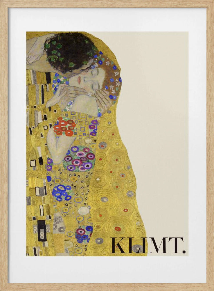 A framed art print of Gustav Klimt's 'The Kiss'. A couple embraces in ornate golden robes against a shimmering gold background. The poster includes the artist's name 'KLIMT.' in the lower right. Decor