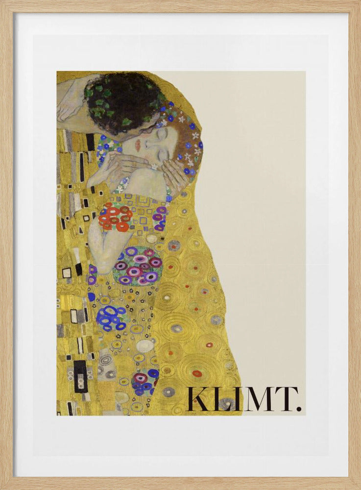 A framed art print of Gustav Klimt's 'The Kiss'. A couple embraces in ornate golden robes against a shimmering gold background. The poster includes the artist's name 'KLIMT.' in the lower right. Decor