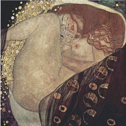 A print of Gustav Klimt's 1907 painting, 'Danaë'. The artwork depicts a sleeping, nude woman with vibrant red hair curled into a fetal position, receiving a shower of golden rain. The style is characteristic of Art Nouveau, with rich, decorative patterns on surrounding fabrics against a dark, star-like background, all within a light wood frame. Wall Art