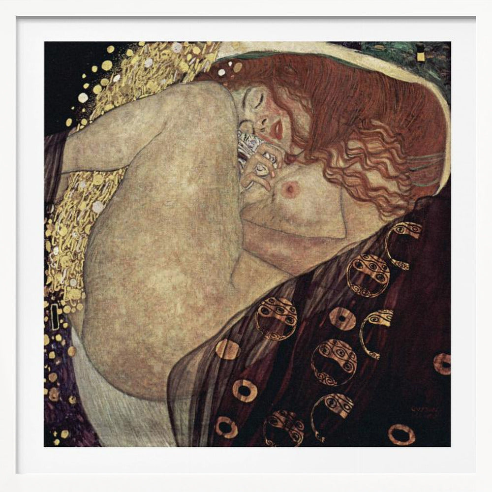 A print of Gustav Klimt's 1907 painting, 'Danaë'. The artwork depicts a sleeping, nude woman with vibrant red hair curled into a fetal position, receiving a shower of golden rain. The style is characteristic of Art Nouveau, with rich, decorative patterns on surrounding fabrics against a dark, star-like background, all within a light wood frame. Wall Art