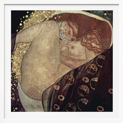 A print of Gustav Klimt's 1907 painting, 'Danaë'. The artwork depicts a sleeping, nude woman with vibrant red hair curled into a fetal position, receiving a shower of golden rain. The style is characteristic of Art Nouveau, with rich, decorative patterns on surrounding fabrics against a dark, star-like background, all within a light wood frame. Wall Art