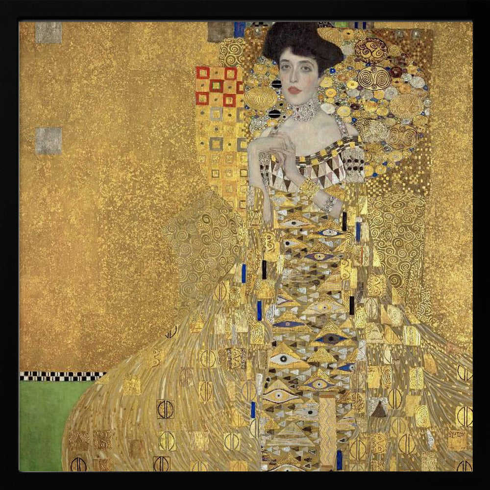 A framed print of Gustav Klimt's 'Portrait of Adele Bloch-Bauer I,' also known as 'The Woman in Gold.' The painting depicts a woman in an ornate, gilded gown covered in intricate patterns, blending into a shimmering gold background characteristic of the Art Nouveau style. Poster