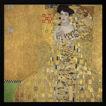 A framed print of Gustav Klimt's 'Portrait of Adele Bloch-Bauer I,' also known as 'The Woman in Gold.' The painting depicts a woman in an ornate, gilded gown covered in intricate patterns, blending into a shimmering gold background characteristic of the Art Nouveau style. Poster