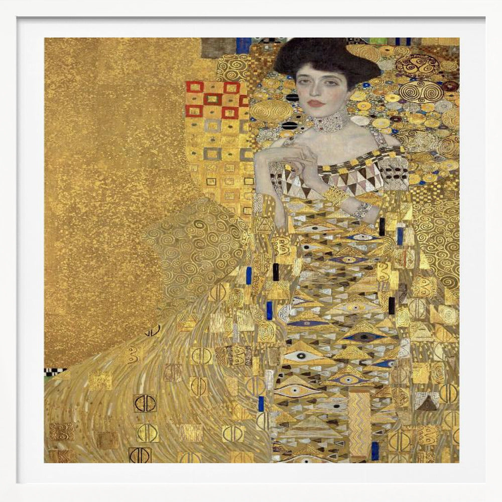 A framed print of Gustav Klimt's 'Portrait of Adele Bloch-Bauer I,' also known as 'The Woman in Gold.' The painting depicts a woman in an ornate, gilded gown covered in intricate patterns, blending into a shimmering gold background characteristic of the Art Nouveau style. Poster