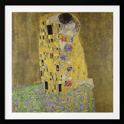 A framed print of Gustav Klimt's famous painting, 'The Kiss'. It features a couple in a passionate embrace, adorned in ornate, patterned golden robes. They are kneeling on a vibrant bed of flowers against a shimmering, textured gold background. Print