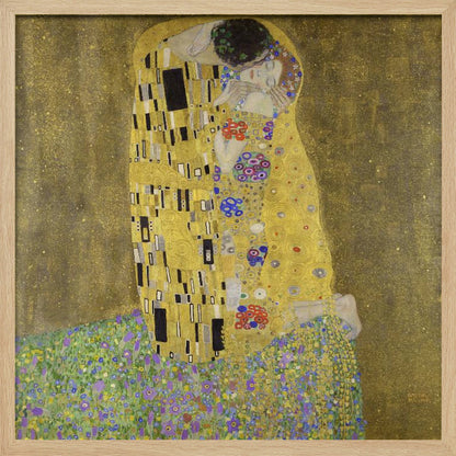 A framed print of Gustav Klimt's famous painting, 'The Kiss'. It features a couple in a passionate embrace, adorned in ornate, patterned golden robes. They are kneeling on a vibrant bed of flowers against a shimmering, textured gold background. Print