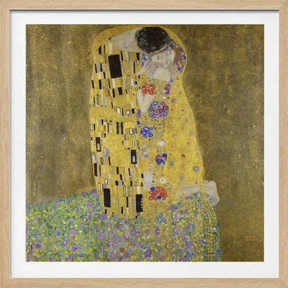 A framed print of Gustav Klimt's famous painting, 'The Kiss'. It features a couple in a passionate embrace, adorned in ornate, patterned golden robes. They are kneeling on a vibrant bed of flowers against a shimmering, textured gold background. Print