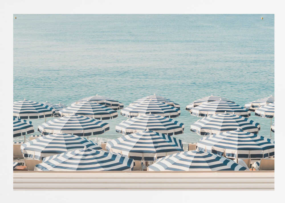 A serene beach scene viewed from above, featuring a multitude of blue and white striped umbrellas lining the shore in front of a calm, turquoise sea. Artwork