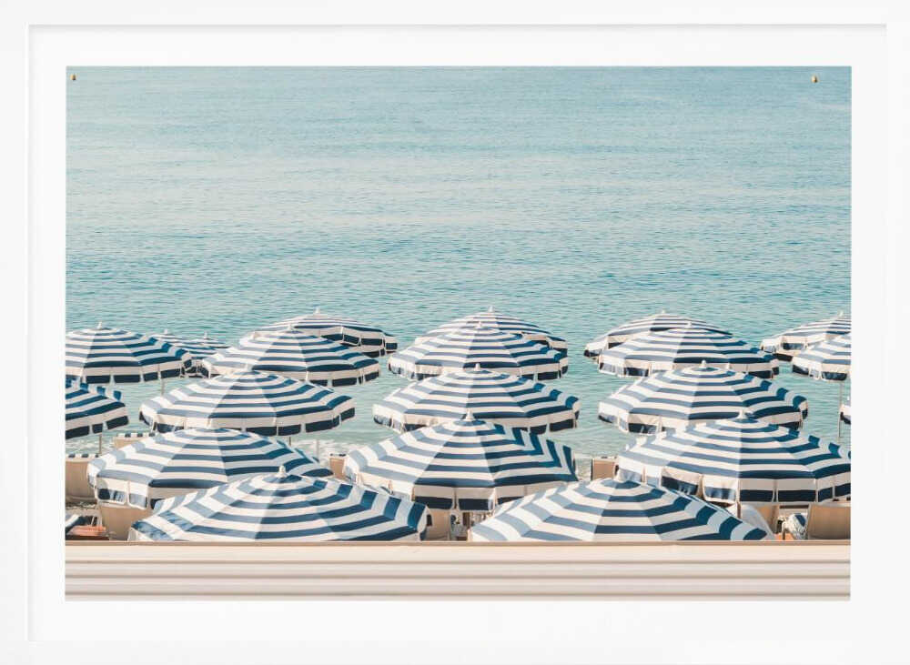 A serene beach scene viewed from above, featuring a multitude of blue and white striped umbrellas lining the shore in front of a calm, turquoise sea. Artwork