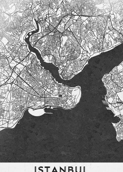 A modern black and white framed poster of a city map of Istanbul. The land is depicted in white with intricate black lines representing streets, while the bodies of water like the Bosphorus are shown in solid textured black. A white banner at the bottom displays the word 'ISTANBUL' in a bold, black, sans-serif font. Artwork