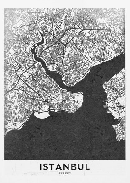 A modern black and white framed poster of a city map of Istanbul. The land is depicted in white with intricate black lines representing streets, while the bodies of water like the Bosphorus are shown in solid textured black. A white banner at the bottom displays the word 'ISTANBUL' in a bold, black, sans-serif font. Artwork
