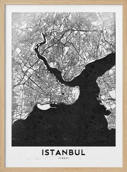 A modern black and white framed poster of a city map of Istanbul. The land is depicted in white with intricate black lines representing streets, while the bodies of water like the Bosphorus are shown in solid textured black. A white banner at the bottom displays the word 'ISTANBUL' in a bold, black, sans-serif font. Artwork