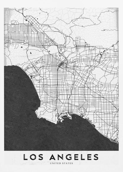 A minimalist black and white framed poster of a street map of Los Angeles. The land is white with an intricate grid of black lines representing roads and highways, while the Pacific Ocean is a solid, textured black. A white band at the bottom contains the city's name, 'LOS ANGELES', in a bold, black sans-serif font. Decor