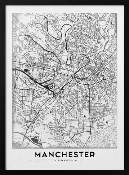A minimalist black and white street map of Manchester, UK, displayed in a simple black frame. The map details the intricate network of roads and waterways, with the city's name 'MANCHESTER' printed in a bold, modern font at the bottom. Wall Art