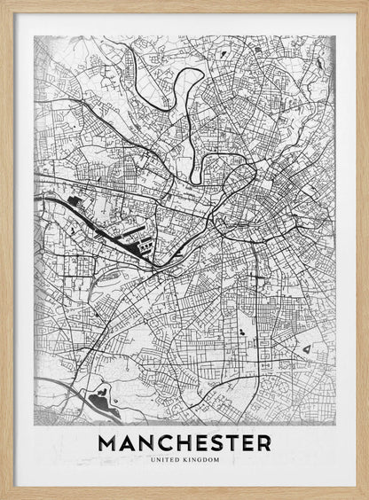 A minimalist black and white street map of Manchester, UK, displayed in a simple black frame. The map details the intricate network of roads and waterways, with the city's name 'MANCHESTER' printed in a bold, modern font at the bottom. Wall Art