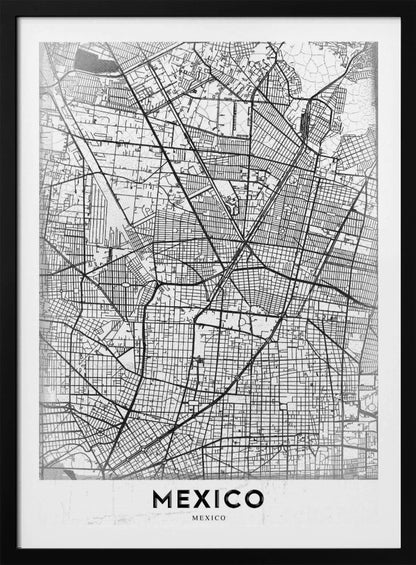 A modern, minimalist black and white art print of a street map of Mexico City, enclosed in a simple black frame. The intricate road network is depicted with black lines on a textured white background. The word 'MEXICO' is printed in bold, black capital letters at the bottom. Print