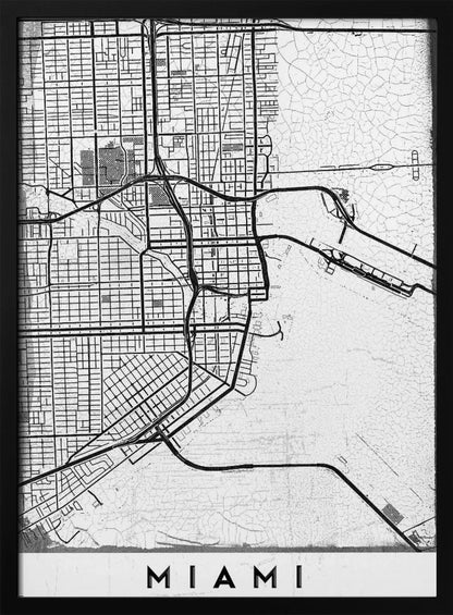 A minimalist black and white street map of Miami, Florida, with a distressed, textured background. The map is framed in black with the word 'MIAMI' printed in bold capital letters at the bottom. Artwork