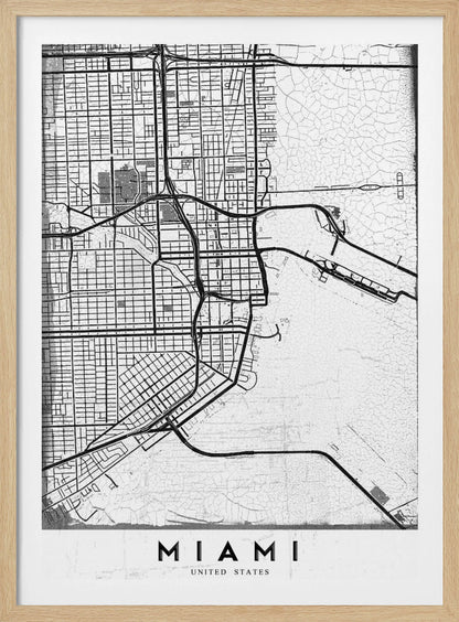 A minimalist black and white street map of Miami, Florida, with a distressed, textured background. The map is framed in black with the word 'MIAMI' printed in bold capital letters at the bottom. Artwork