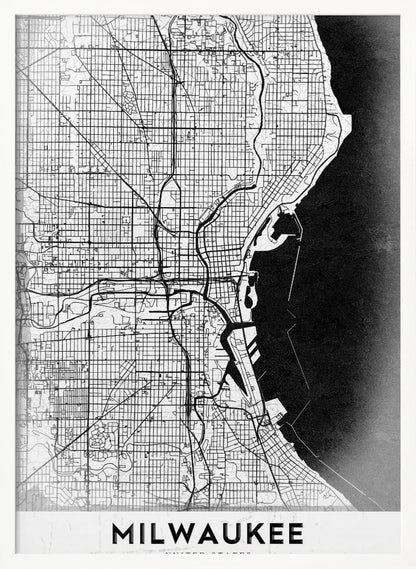 A minimalist, black and white street map of Milwaukee, displayed in a black frame. The map details the city's grid system, major roads, and waterways against a textured background, with the word 'MILWAUKEE' in a bold, sans-serif font at the bottom. Poster