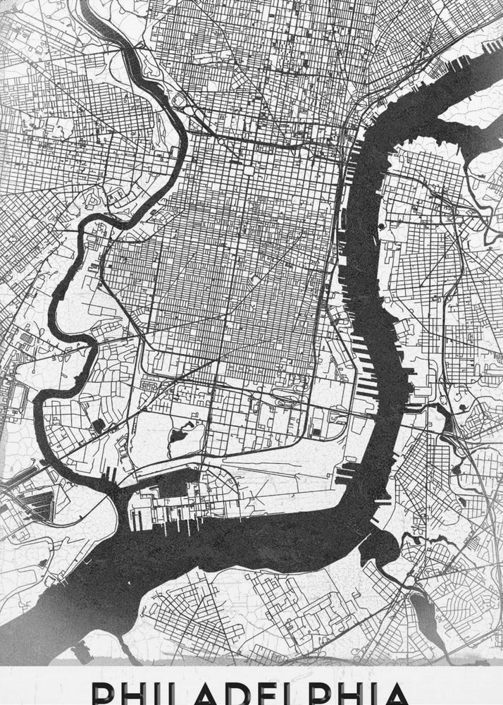 A modern black and white framed poster of a city map of Philadelphia. The map details the street grid, with the Schuylkill and Delaware rivers prominently featured in solid black. The word 'PHILADELPHIA' is printed in a bold, black sans-serif font at the bottom. Artwork