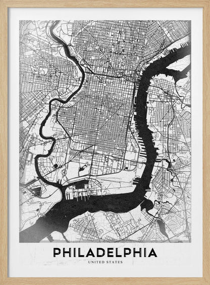 A modern black and white framed poster of a city map of Philadelphia. The map details the street grid, with the Schuylkill and Delaware rivers prominently featured in solid black. The word 'PHILADELPHIA' is printed in a bold, black sans-serif font at the bottom. Artwork
