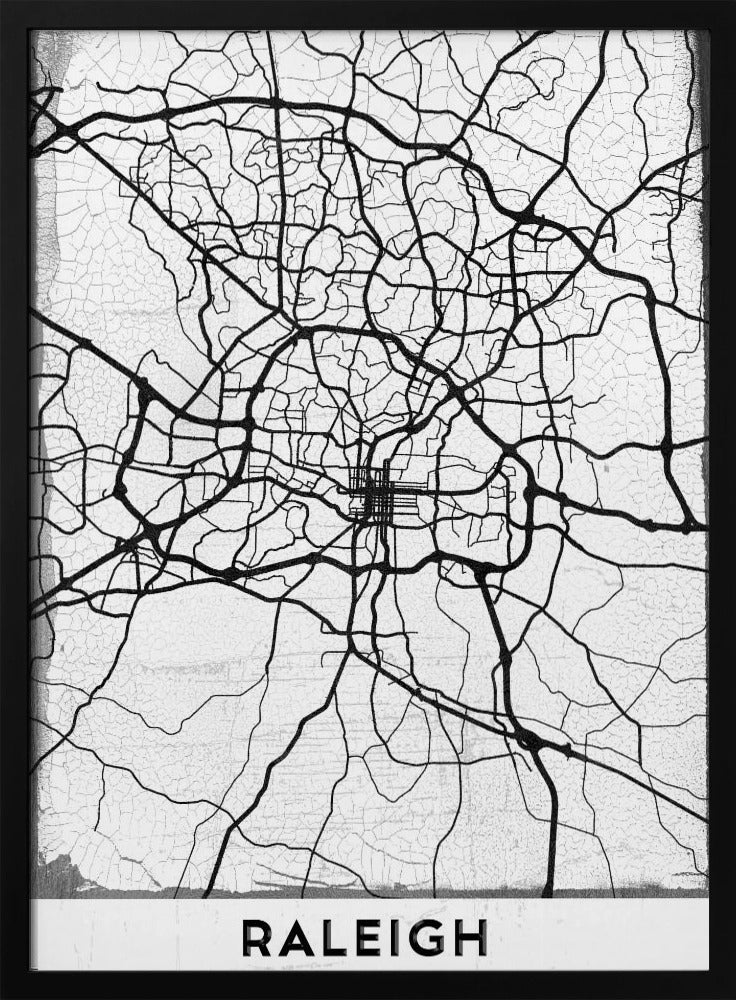A minimalist black and white street map of Raleigh, North Carolina, displayed in a black frame. The map features black lines representing roads on a distressed, crackled white background. At the bottom, the word 'RALEIGH' is printed in a bold, black, sans-serif font. Print
