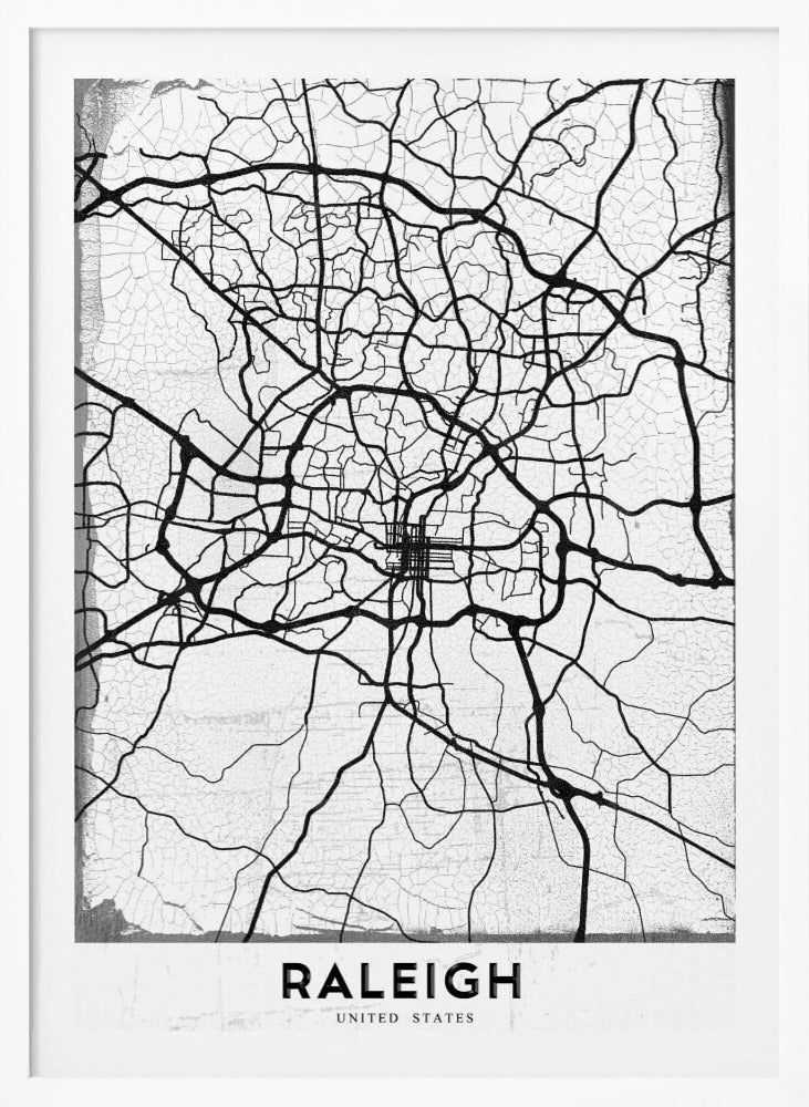 A minimalist black and white street map of Raleigh, North Carolina, displayed in a black frame. The map features black lines representing roads on a distressed, crackled white background. At the bottom, the word 'RALEIGH' is printed in a bold, black, sans-serif font. Print