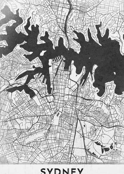 A modern black and white framed art print of a city map of Sydney, Australia. The water bodies are shown in solid textured black, while the land is depicted with a detailed white street grid. At the bottom, the word 'SYDNEY' is printed in bold capital letters. Poster