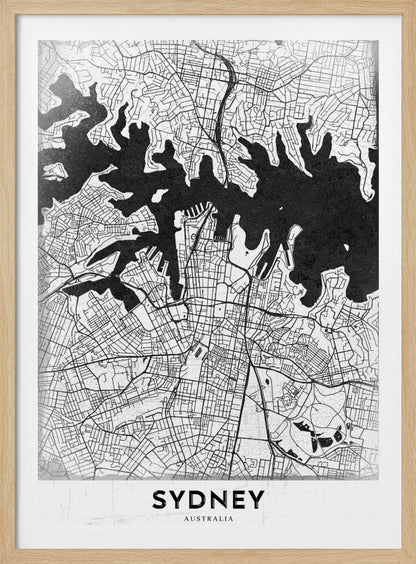 A modern black and white framed art print of a city map of Sydney, Australia. The water bodies are shown in solid textured black, while the land is depicted with a detailed white street grid. At the bottom, the word 'SYDNEY' is printed in bold capital letters. Poster