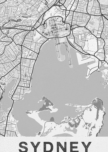 A modern, black and white framed art print of a stylized map of Sydney, Australia. The map features bold black lines for the street grid and major roads, with light grey for the landmass and a darker grey for the water of the harbor. The word 'SYDNEY' is printed in large, black, sans-serif font at the bottom of the poster. Poster