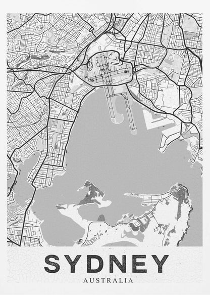 A modern, black and white framed art print of a stylized map of Sydney, Australia. The map features bold black lines for the street grid and major roads, with light grey for the landmass and a darker grey for the water of the harbor. The word 'SYDNEY' is printed in large, black, sans-serif font at the bottom of the poster. Poster