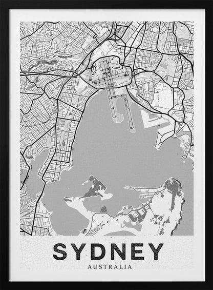 A modern, black and white framed art print of a stylized map of Sydney, Australia. The map features bold black lines for the street grid and major roads, with light grey for the landmass and a darker grey for the water of the harbor. The word 'SYDNEY' is printed in large, black, sans-serif font at the bottom of the poster. Poster