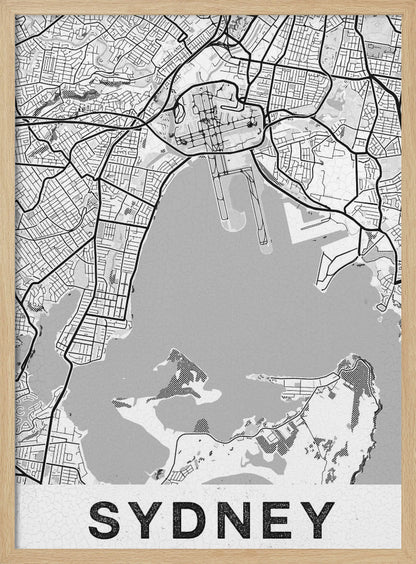 A modern, black and white framed art print of a stylized map of Sydney, Australia. The map features bold black lines for the street grid and major roads, with light grey for the landmass and a darker grey for the water of the harbor. The word 'SYDNEY' is printed in large, black, sans-serif font at the bottom of the poster. Poster