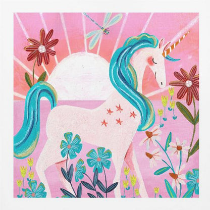 A whimsical painting of a serene white unicorn with a vibrant blue mane and tail, standing in a field of colorful flowers. The background features a large white sun against a pink sky with a dragonfly flying overhead. The artwork is presented in a light wood frame. Print