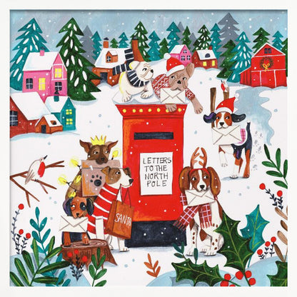 A whimsical Christmas illustration of several dogs in festive hats and scarves mailing letters at a bright red postbox labeled 'Letters to the North Pole' in a snowy village scene with colorful houses and pine trees. Decor