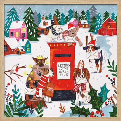 A whimsical Christmas illustration of several dogs in festive hats and scarves mailing letters at a bright red postbox labeled 'Letters to the North Pole' in a snowy village scene with colorful houses and pine trees. Decor