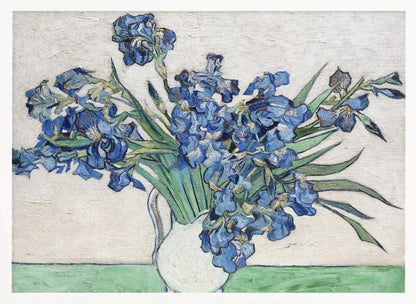 A framed print of Vincent van Gogh's famous painting 'Irises'. It features a large bouquet of vibrant blue iris flowers with long green leaves, arranged in a simple white pitcher. The background is a textured off-white wall, and the pitcher rests on a light green surface. The painting is in the post-impressionist style with thick, visible brushstrokes. Wall Art