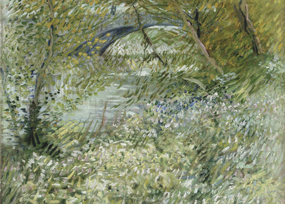 A framed impressionist painting by Vincent van Gogh, depicting the banks of a river. The scene is lush with green foliage and trees. In the foreground, white and blue flowers bloom in the tall grass. A bridge is partially visible in the background through the leaves. The brushwork is energetic and textured. Print
