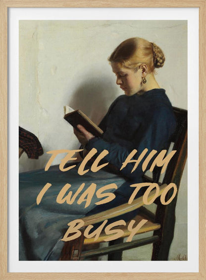 A classical painting of a woman in a blue dress sitting in a wooden chair, engrossed in reading a book. Overlaid in a modern, tan-colored brush script font is the phrase 'TELL HIM I WAS TOO BUSY'. Wall Art