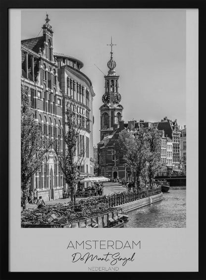 A black and white travel poster of Amsterdam, Netherlands. The photo shows the Munttoren clock tower and traditional Dutch buildings along the Singel canal. A floating barge filled with bicycles is in the foreground. The poster has a white border with the text 'AMSTERDAM', 'De Munt, Singel', and 'NEDERLAND' at the bottom. Artwork