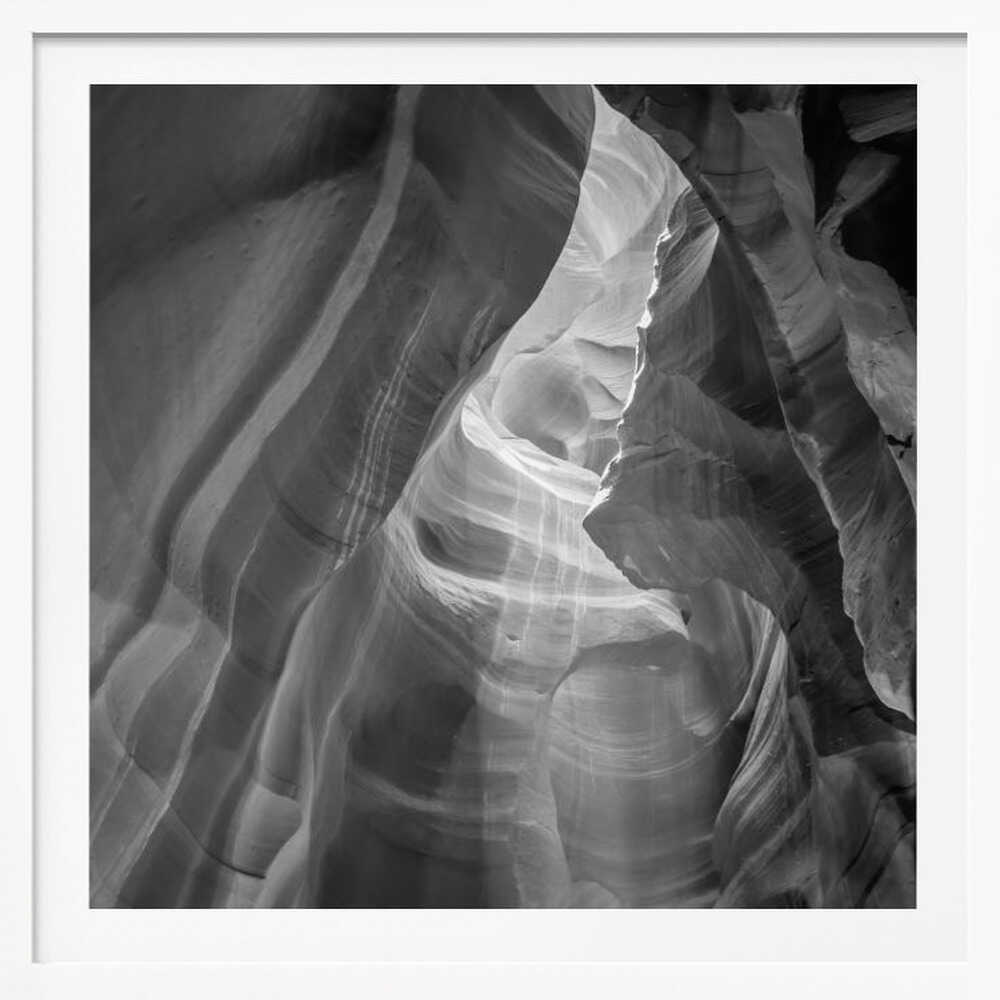 Black and white photo of light in a narrow slot canyon, highlighting smooth, layered rock formations. Nature wall art.