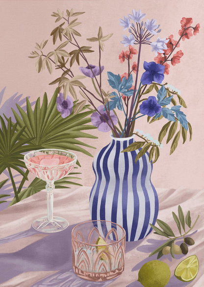 A vibrant still life painting featuring a blue and white striped wavy vase filled with a colorful bouquet of flowers. To the left is a pink cocktail in a coupe glass and a decorative tumbler. In the foreground, there are fresh limes and an olive branch. The scene is set on a draped pink cloth against a soft pink background with shadows from palm leaves. Artwork