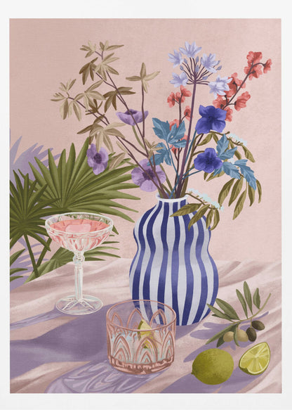 A vibrant still life painting featuring a blue and white striped wavy vase filled with a colorful bouquet of flowers. To the left is a pink cocktail in a coupe glass and a decorative tumbler. In the foreground, there are fresh limes and an olive branch. The scene is set on a draped pink cloth against a soft pink background with shadows from palm leaves. Artwork