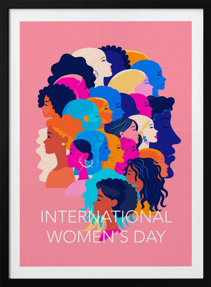 A vibrant poster for International Women's Day featuring a pink background. The central graphic is a collage of colorful profiles of diverse women, representing different ethnicities and hairstyles, all looking in the same direction. Below the illustration, white text reads 'INTERNATIONAL WOMEN'S DAY'. Wall Art